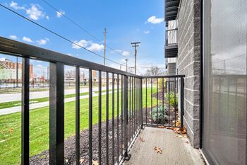 A black metal fence leads to a building entrance. at Park Lamont Townhomes Apartments, Cleveland 44106